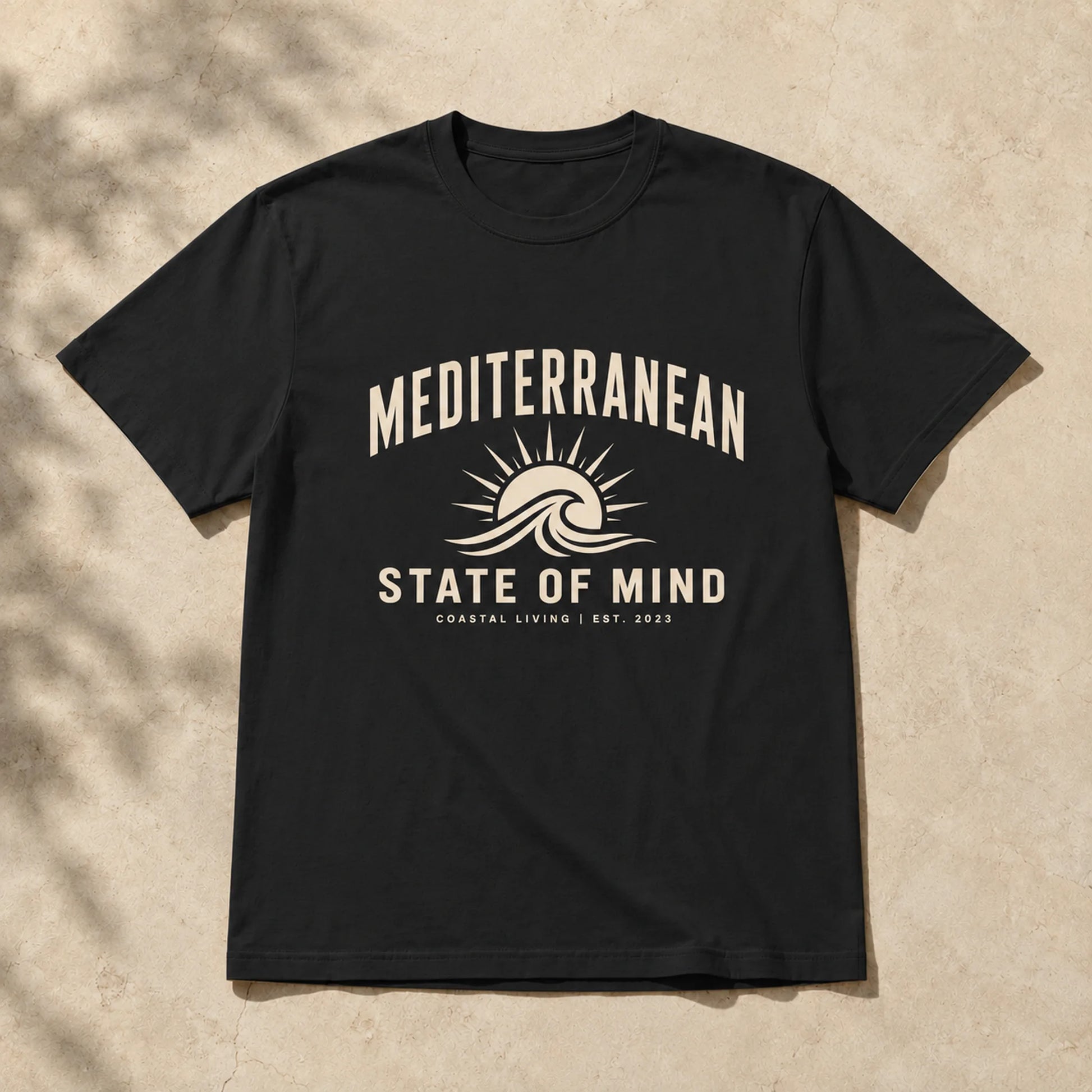 Black t-shirt with 'Mediterranean State of Mind' design on a beige background
