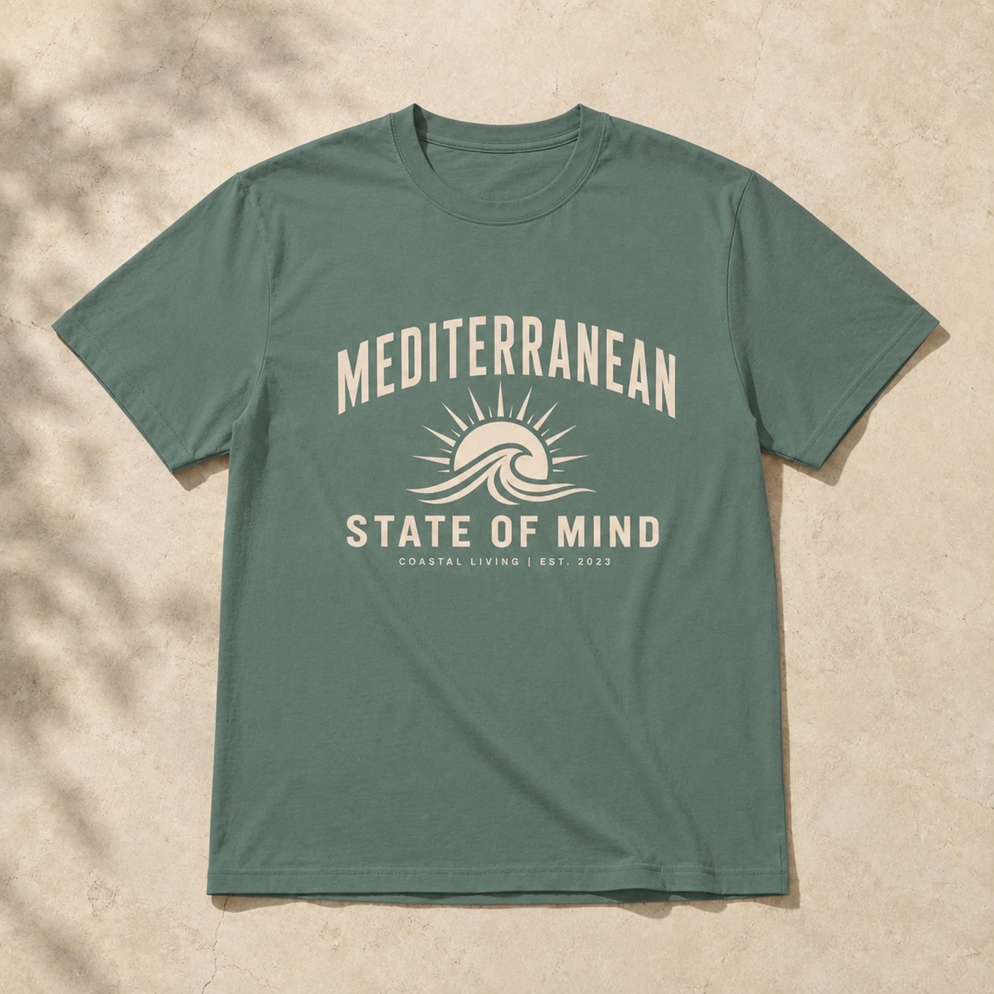 Green t-shirt with 'Mediterranean State of Mind' design on a beige background