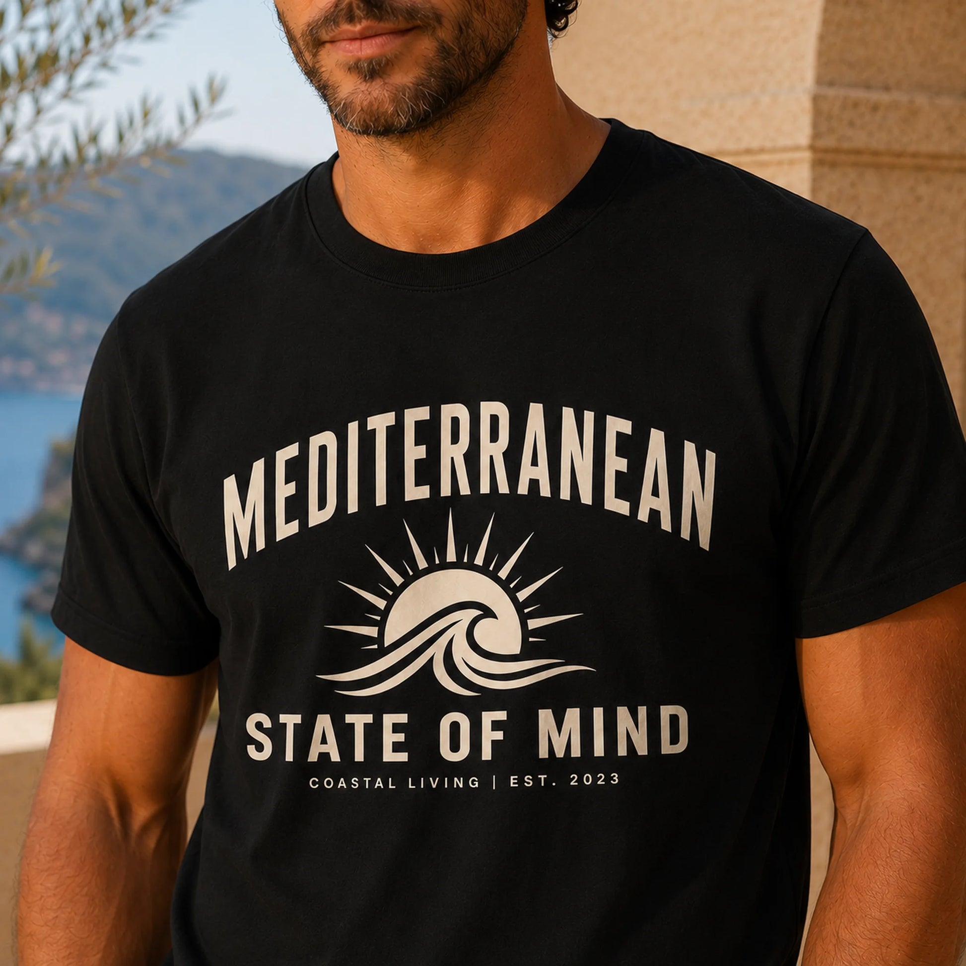 TP HERO: Man wearing a black t-shirt with 'Mediterranean State of Mind' design outdoors.