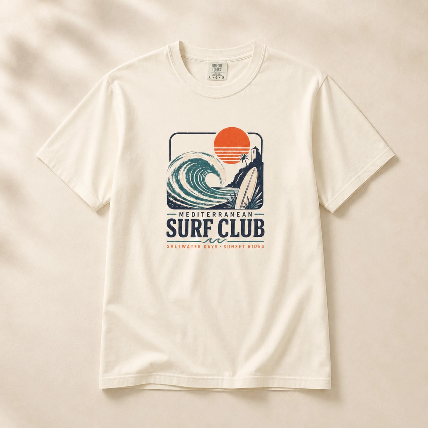 White t-shirt with 'Mediterranean Surf Club' graphic on a beige background