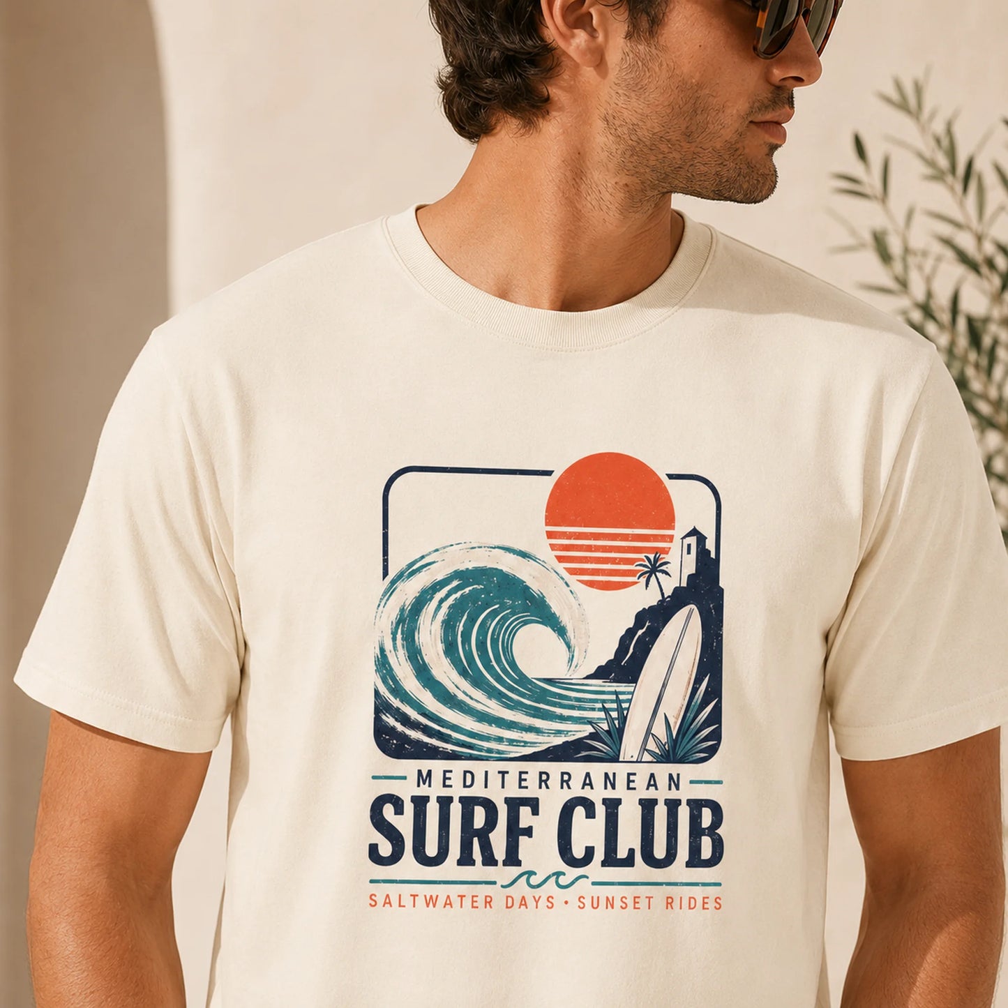 TP HERO: Man wearing a white t-shirt with a 'Mediterranean Surf Club' graphic design.