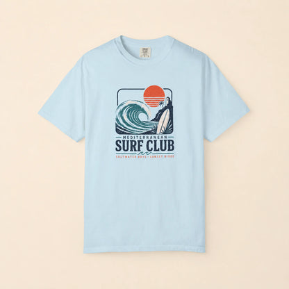 Light blue t-shirt with a surf club graphic on a beige background