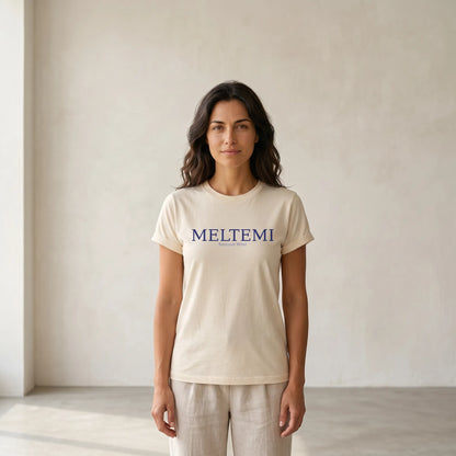 Woman wearing a beige t-shirt with 'MELTEMI' logo against a plain background