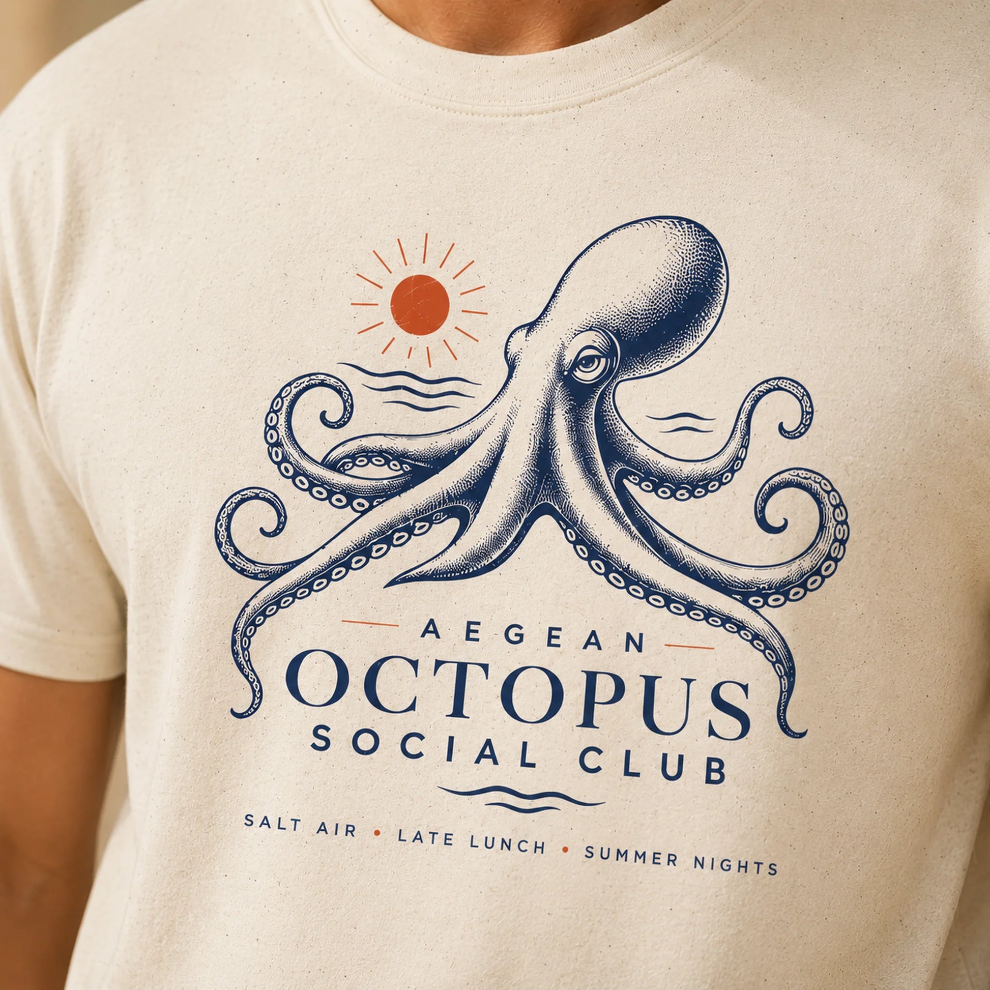 Beige t-shirt with an octopus design and text on a person wearing it.