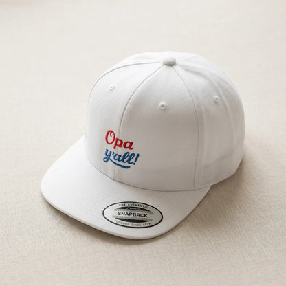 White cap with 'Opa y'all!' text on a beige background