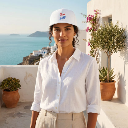 Woman wearing a white shirt and cap with a scenic background