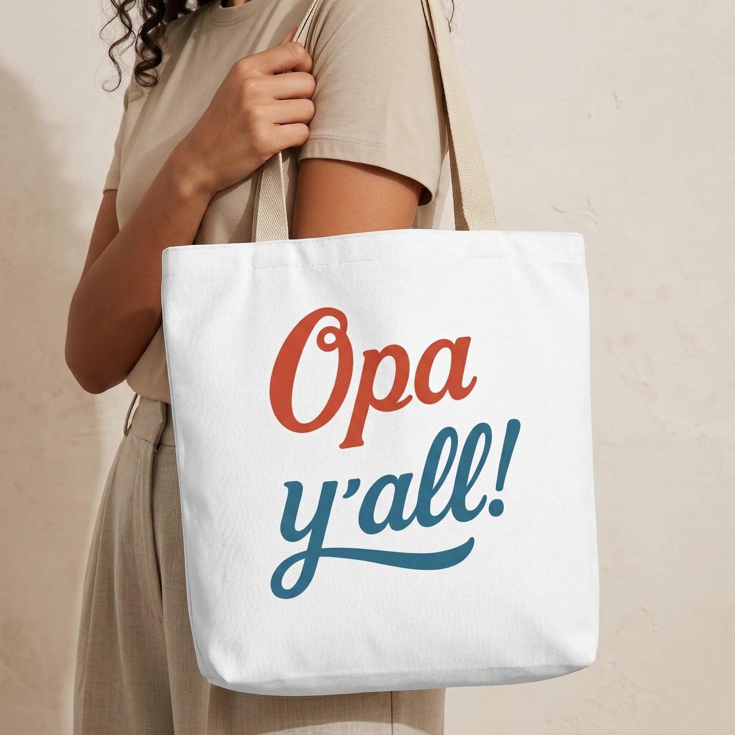 TP HERO: Close-up lifestyle mockup of Opa y’all Greek summer tote bag with beige handles, focused mainly on the printed design