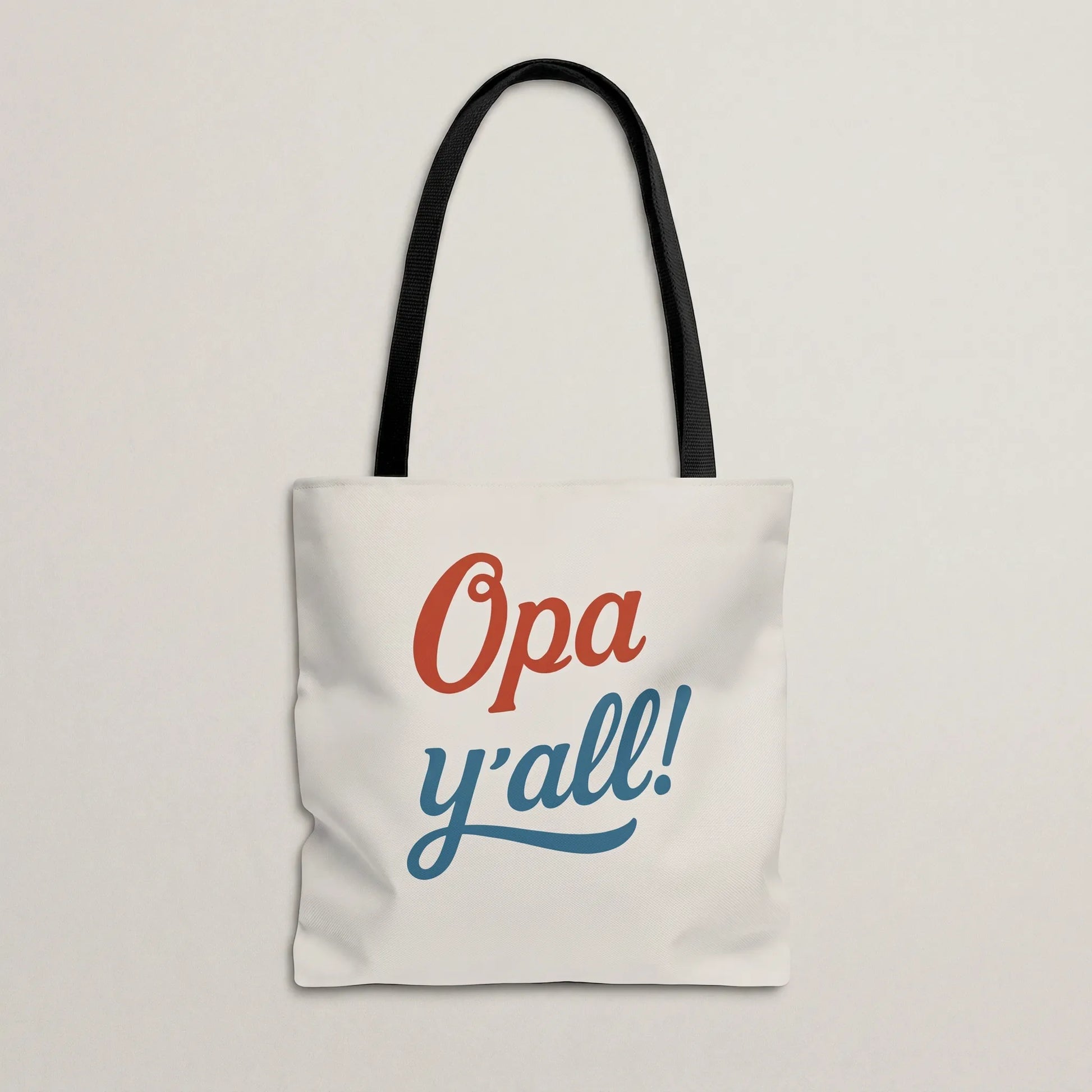 Opa y’all Greek summer tote bag with black handles in a minimal flat lay mockup