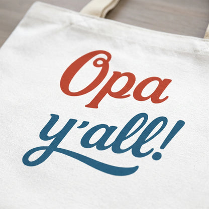 Close-up detail of the Opa y’all Greek summer tote bag print showing the red and blue phrase design clearly
