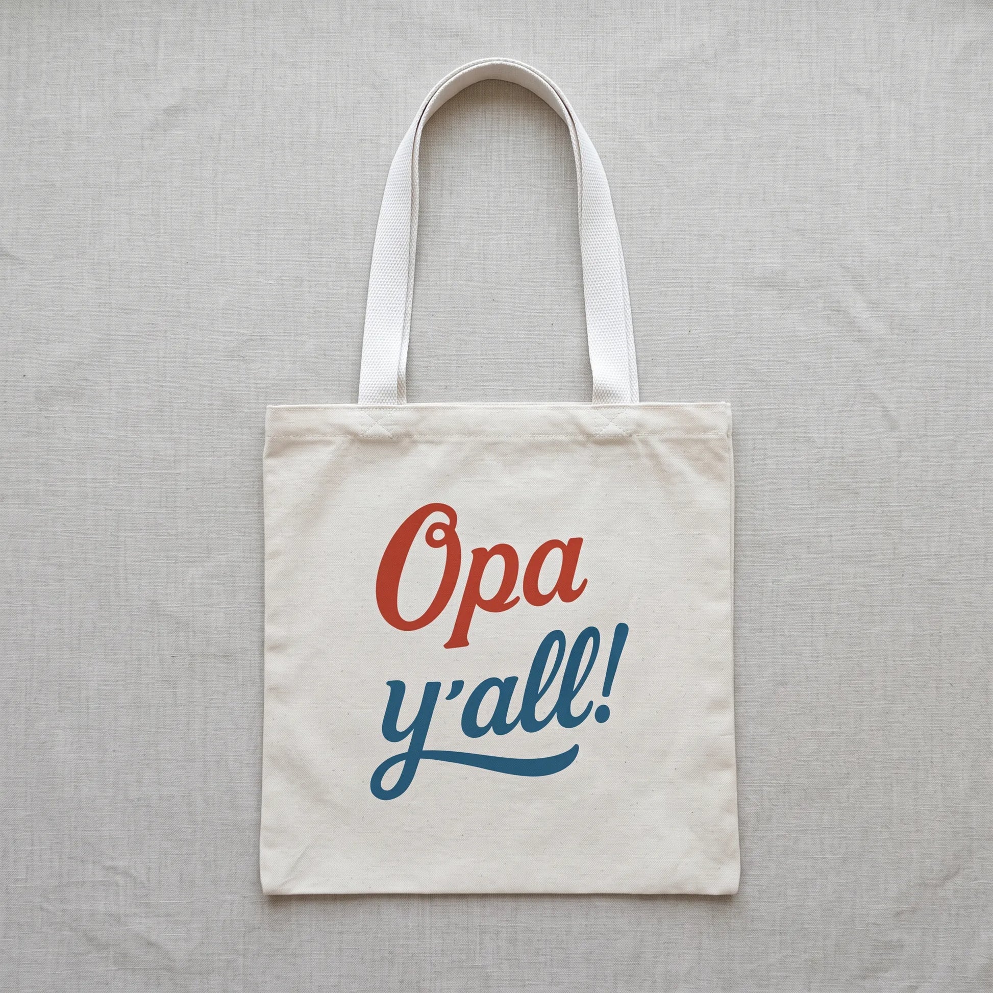 Opa y’all Greek summer tote bag with white handles in a clean flat lay product mockup