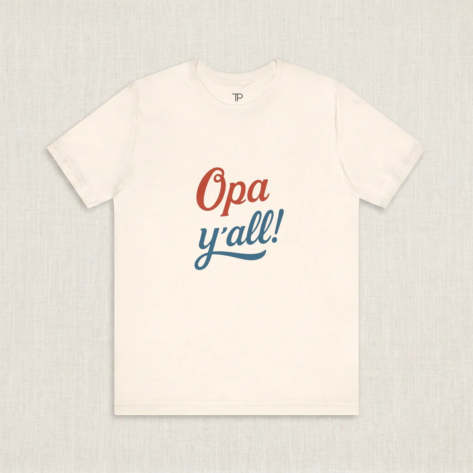 White t-shirt with 'Opa y'all!' text on a light gray background