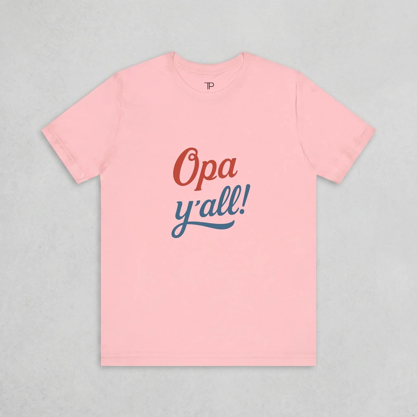 Pink t-shirt with 'Opa y'all!' text on a gray background