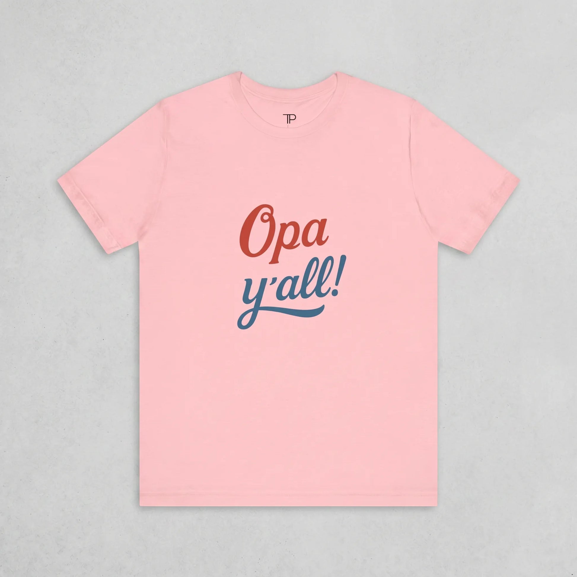 Pink t-shirt with 'Opa y'all!' text on a gray background