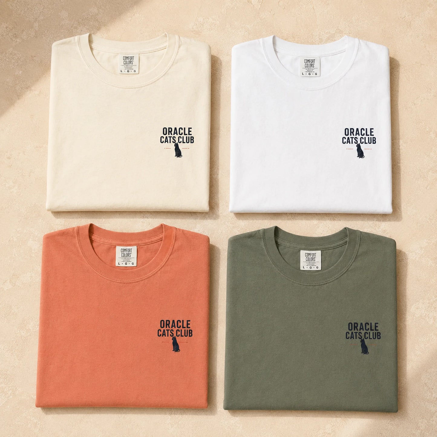 Four folded t-shirts in beige, white, orange, and green with 'Oracle Cats Club' text on a beige background.