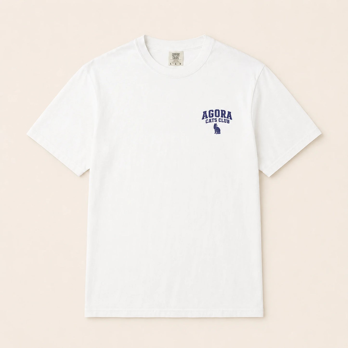 White t-shirt with 'AGORA CATS CLUB' text and logo on a beige background