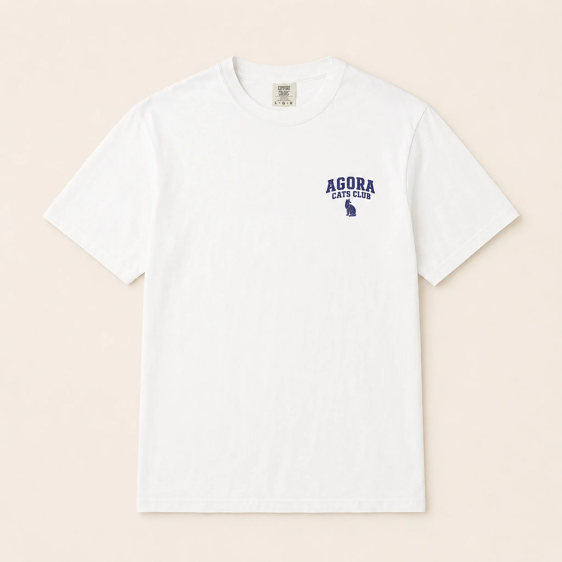 White t-shirt with 'AGORA CATS CLUB' text and logo on a beige background