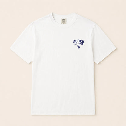 White t-shirt with 'AGORA CATS CLUB' text and logo on a beige background