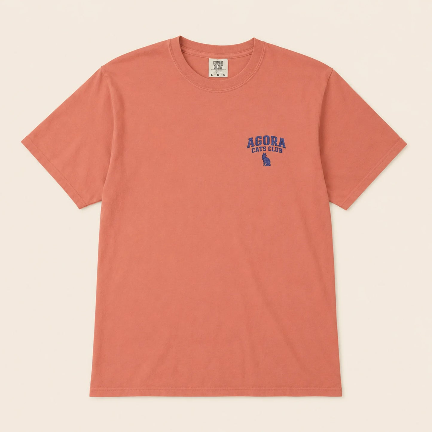 Coral t-shirt with 'Agora Cats Club' logo on a beige background