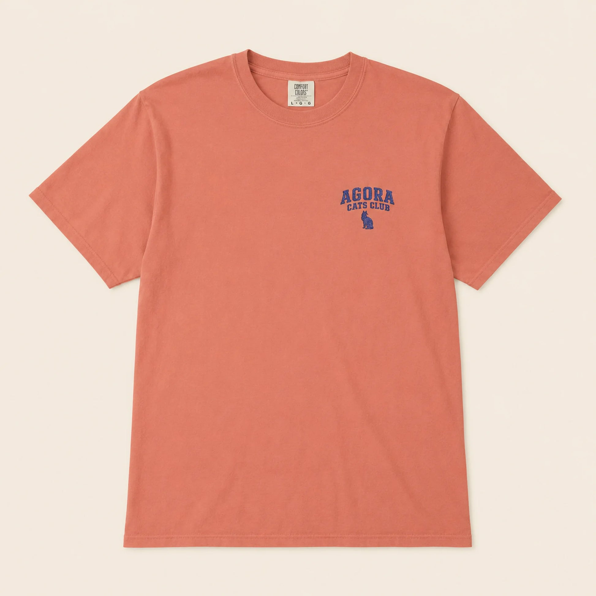 Coral t-shirt with 'Agora Cats Club' logo on a beige background
