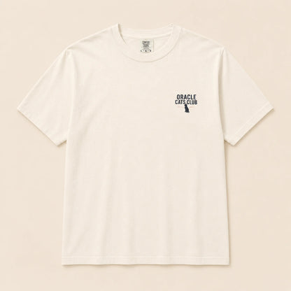 White t-shirt with 'Oracle Cats Club' logo on a beige background