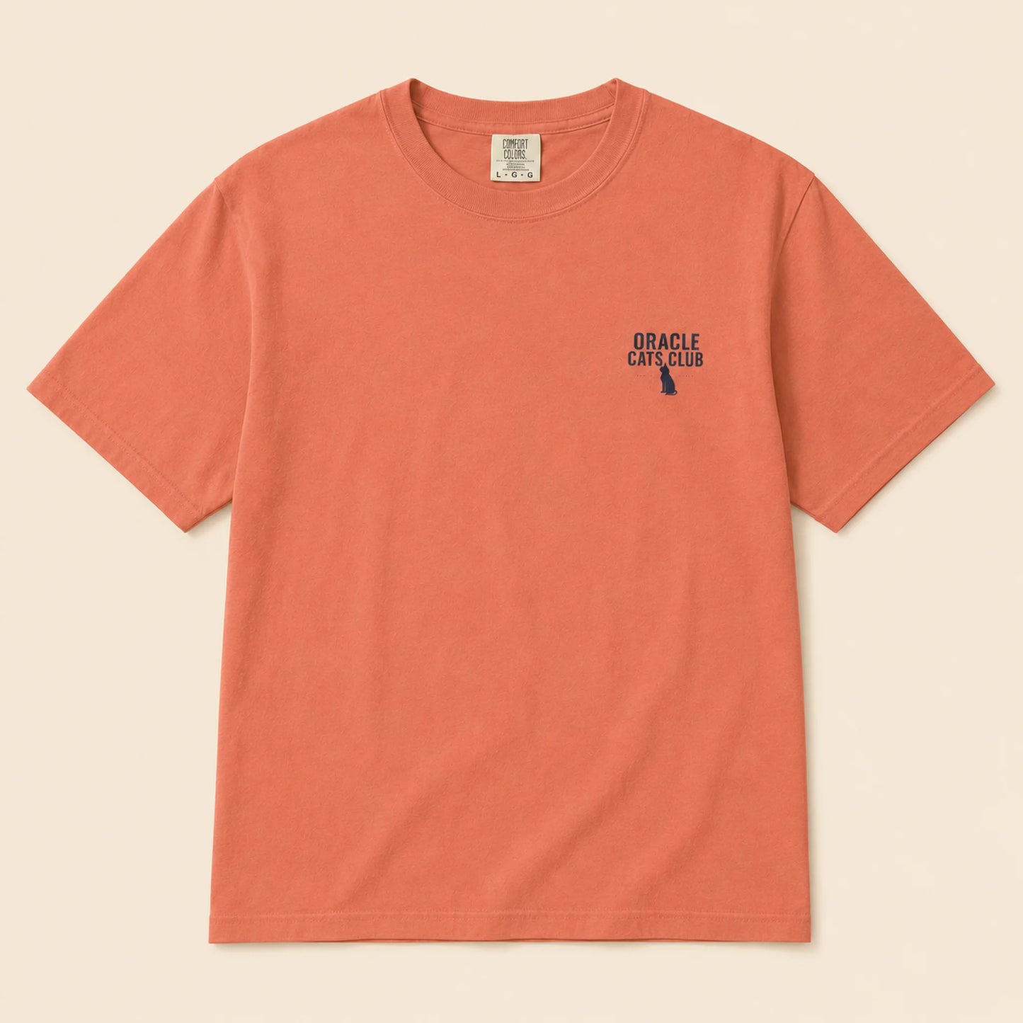 Coral t-shirt with 'Oracle Cats Club' logo on a beige background