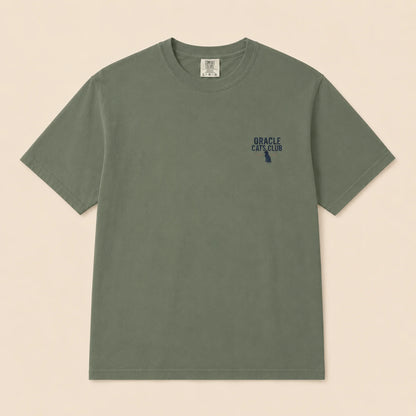 Green t-shirt with a small logo on a beige background