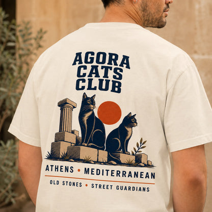 TP HERO: Person wearing a t-shirt with 'Agora Cats Club' design featuring cats and architectural elements.
