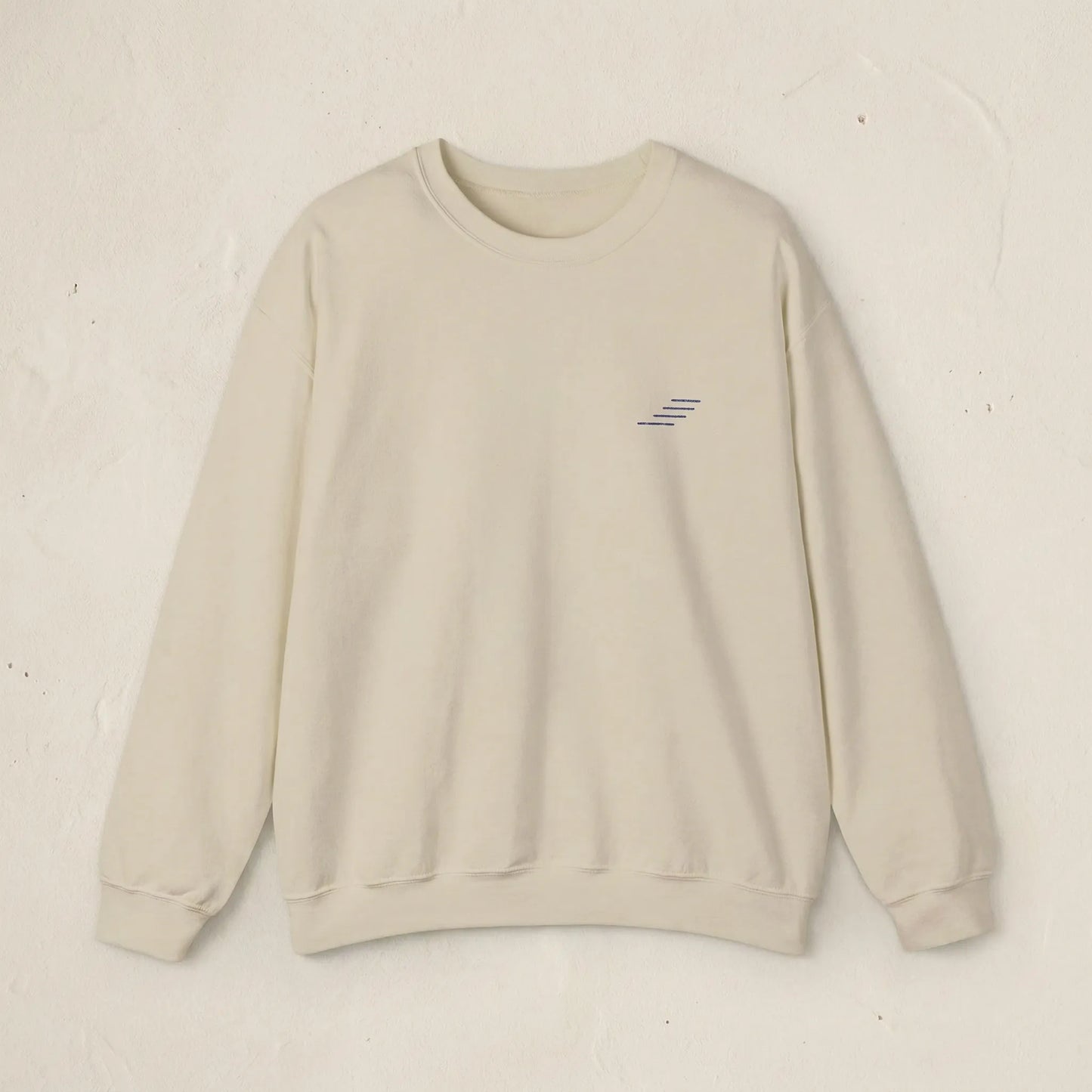 Beige sweatshirt with a small logo on a light beige background
