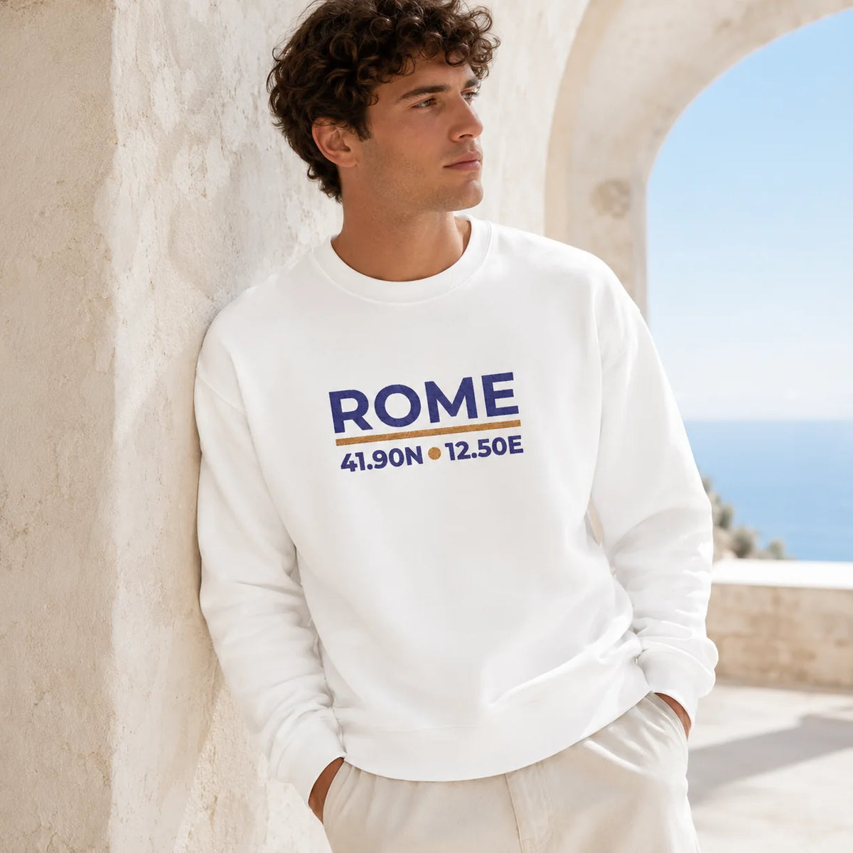 Male model wearing the White Rome Coordinates Embroidered Sweatshirt, showing the embroidered front design.