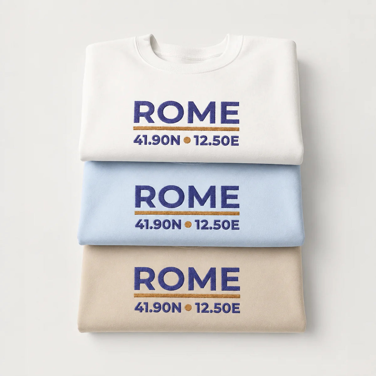 Rome Coordinates Light Edition color overview with folded Sand, Light Blue and White embroidered crewneck sweatshirts.