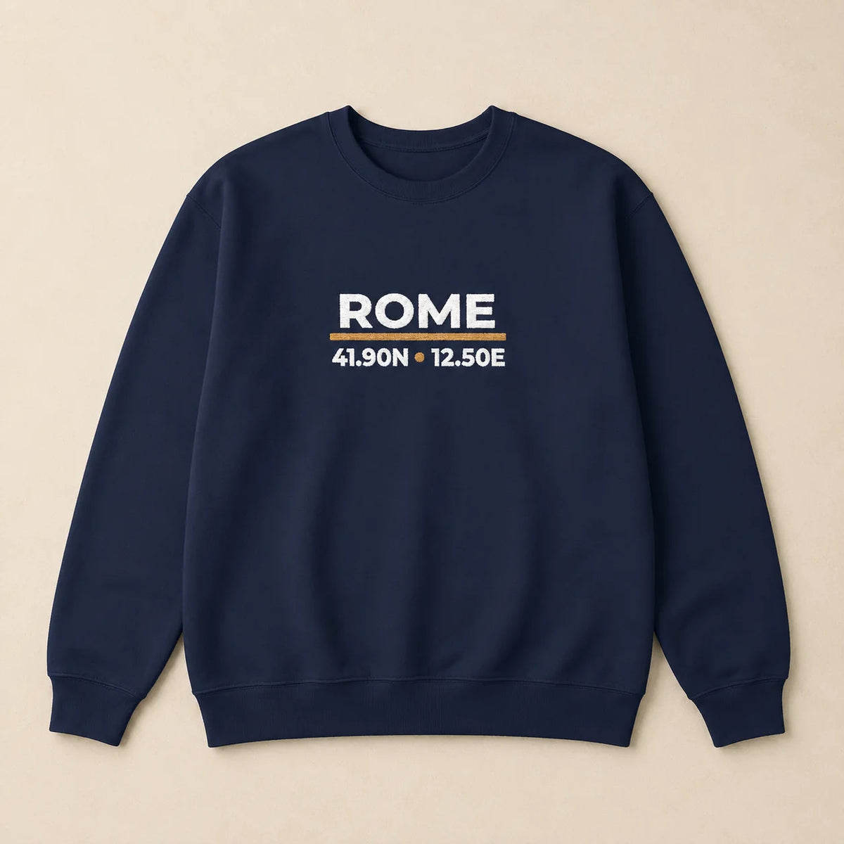 A navy blue crewneck sweatshirt with 'ROME' and coordinates embroidered on the chest, displayed flat against a light beige background.