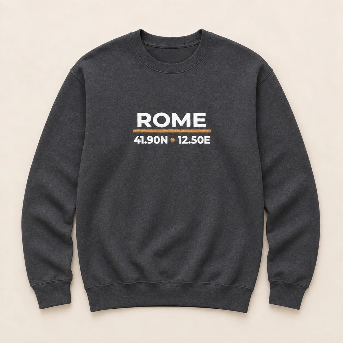 A dark charcoal gray crewneck sweatshirt with 'ROME' and coordinates embroidered on the chest, displayed flat against a light beige background.