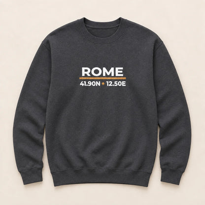 A dark charcoal gray crewneck sweatshirt with 'ROME' and coordinates embroidered on the chest, displayed flat against a light beige background.