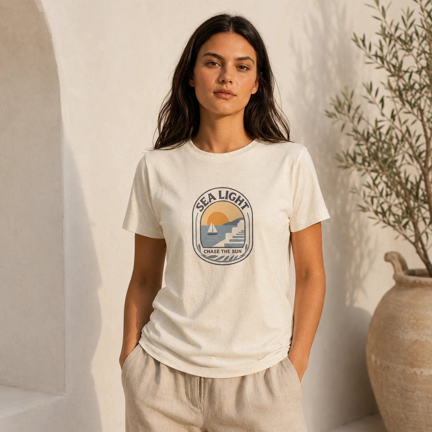 Woman wearing a white t-shirt with 'Sea Light' logo against a neutral background