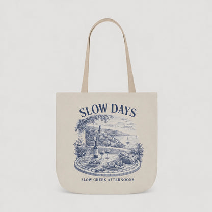Beige tote bag with blue graphic and text on a light gray background