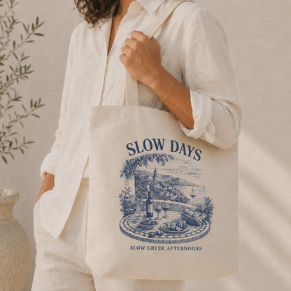 TP HERO: Person holding a tote bag with 'Slow Days' design and text.
