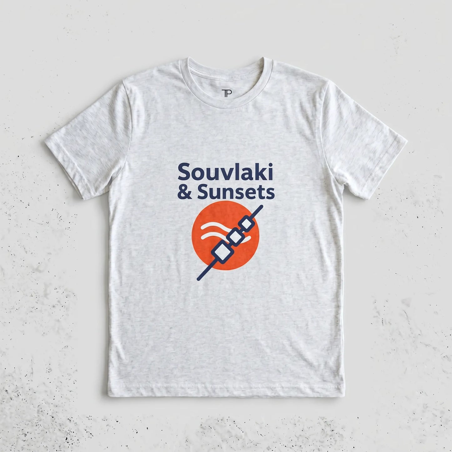 White t-shirt with 'Souvlaki & Sunsets' design on a light gray background