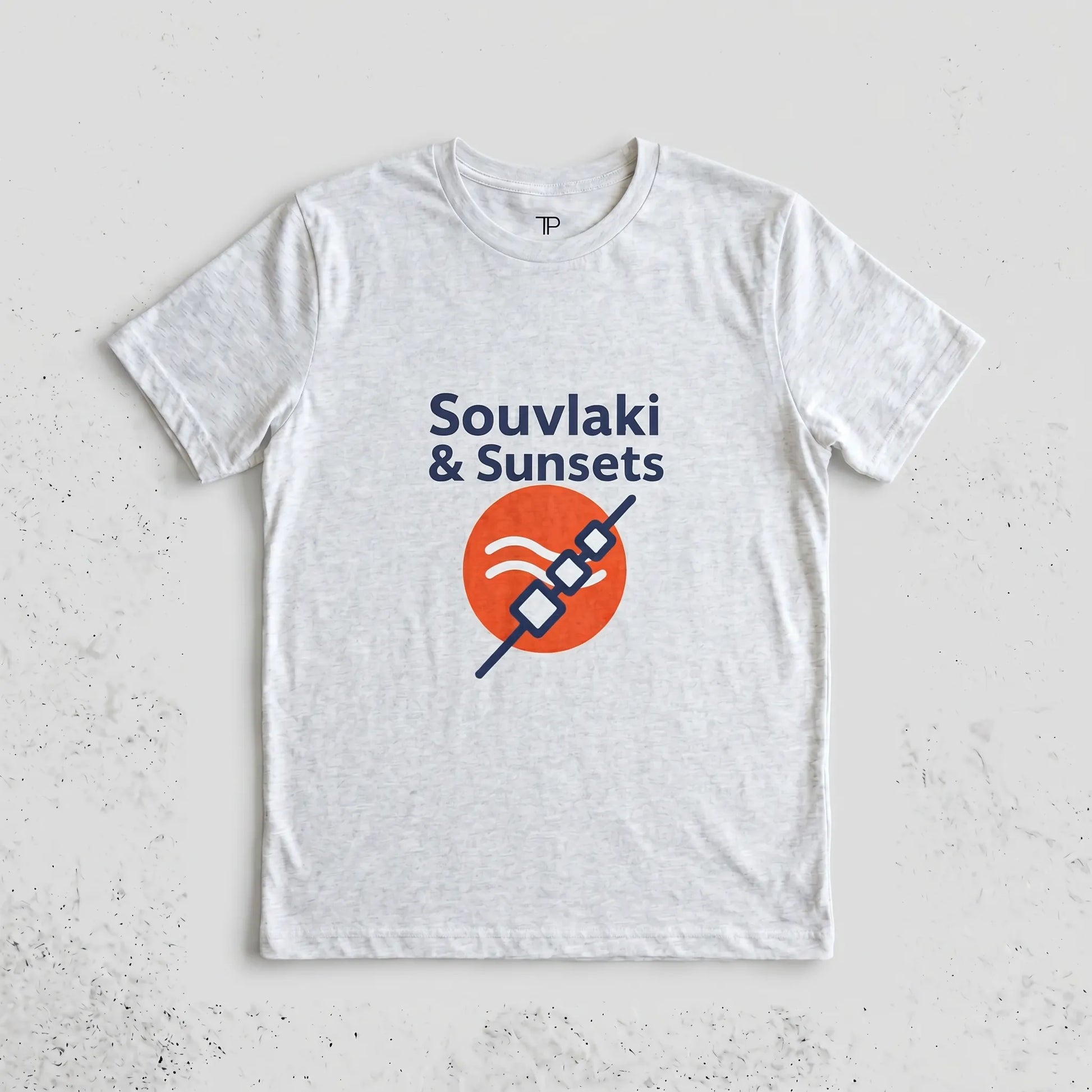 White t-shirt with 'Souvlaki & Sunsets' design on a light gray background
