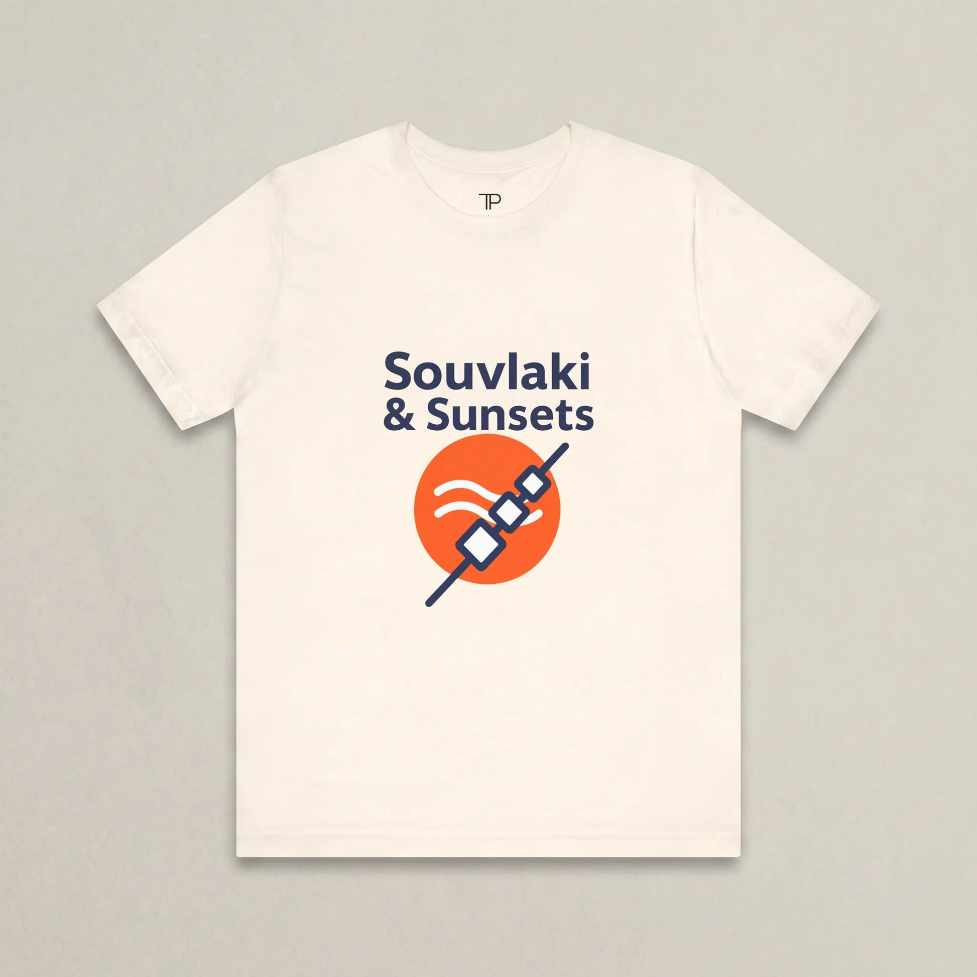 White t-shirt with 'Souvlaki & Sunsets' design on a gray background