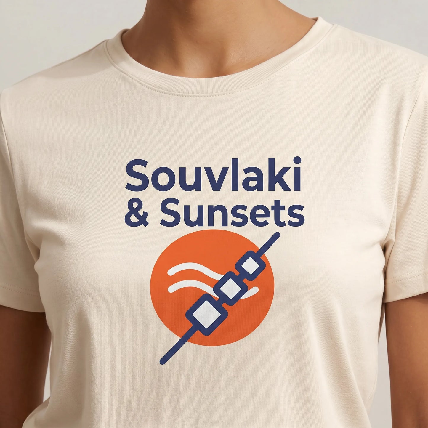 TP HERO: Beige t-shirt with 'Souvlaki & Sunsets' graphic design on a plain background