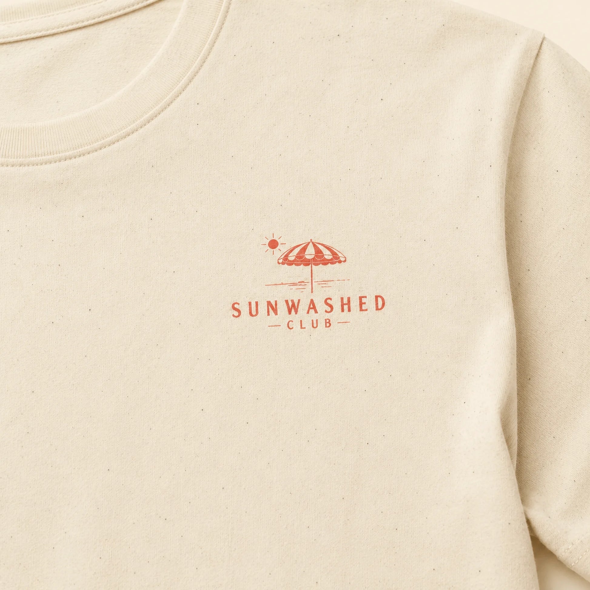 Beige sweatshirt with 'Sunwashed Club' logo on a beige background
