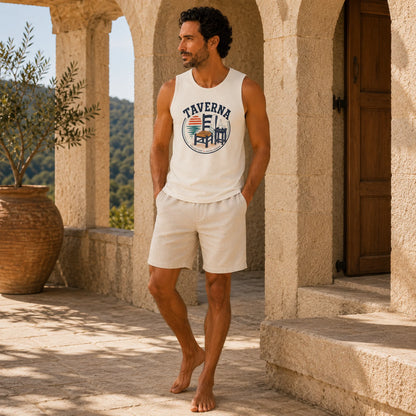 Man wearing a white tank top with 'Taverna' logo and shorts, standing in a sunlit outdoor setting.