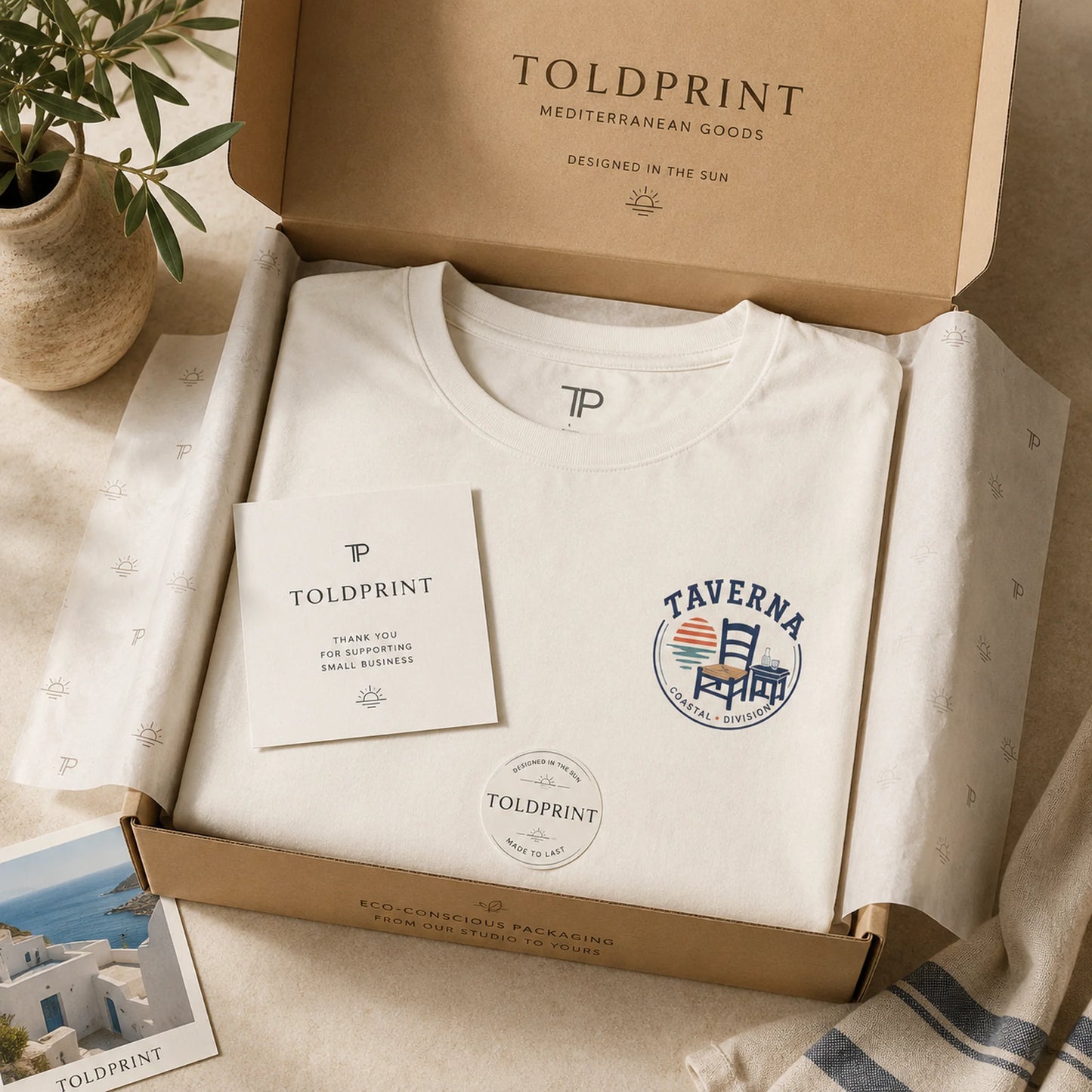 Folded white t-shirt with 'Taverna' logo in a Toldprint box.