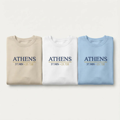 Athens coordinates embroidered crewneck sweatshirt color lineup showing Sand, White, and Light Blue options with navy and gold chest embroidery.