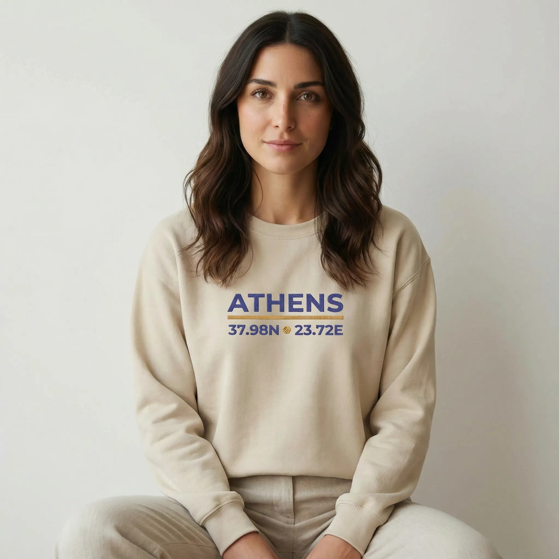 TP:HERO Model wearing sand Athens coordinates embroidered crewneck sweatshirt in a clean studio setting