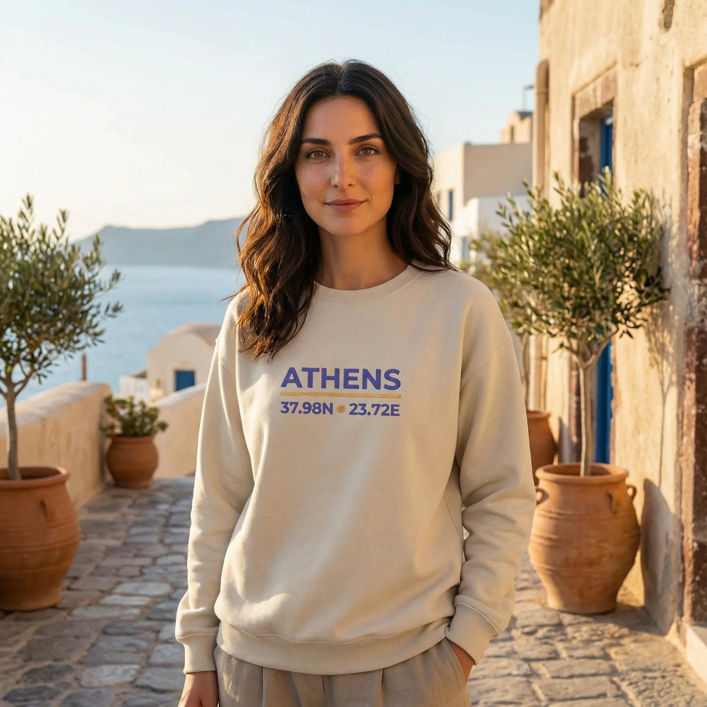 Model wearing sand Athens coordinates sweatshirt in Mediterranean outdoor setting