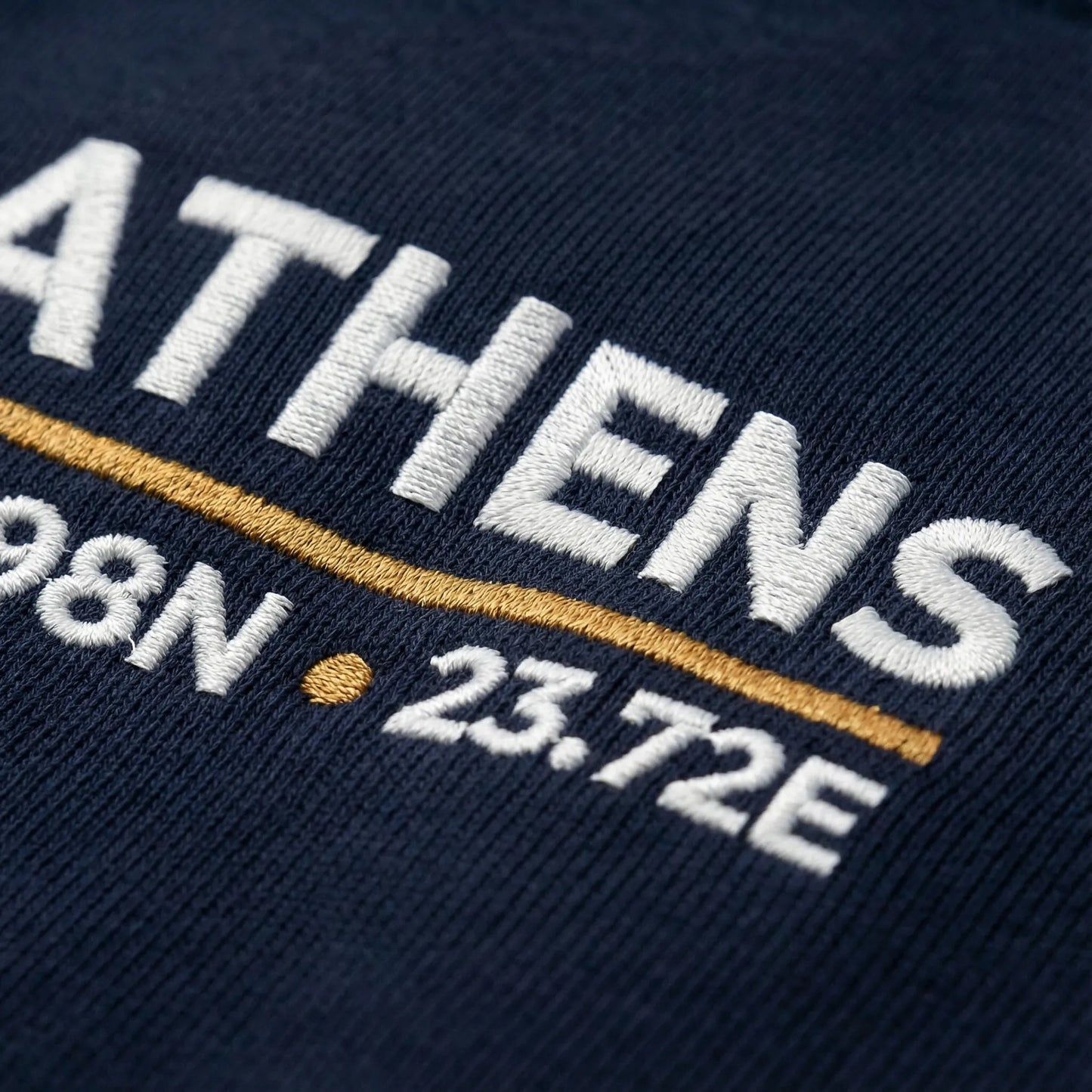 Close-up of embroidered Athens coordinates detail on crewneck sweatshirt