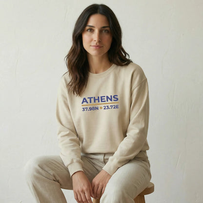 Relaxed seated studio lifestyle shot of model wearing sand Athens embroidered sweatshirt