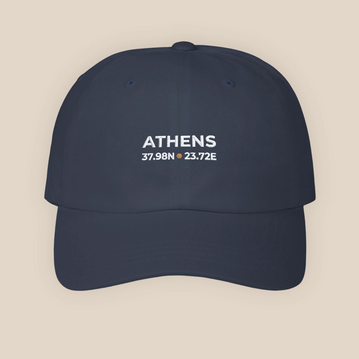 Navy blue cap with 'ATHENS' and coordinates on a beige background