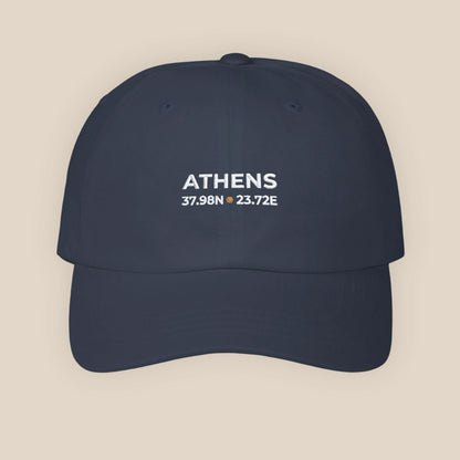 Navy blue cap with 'ATHENS' and coordinates on a beige background
